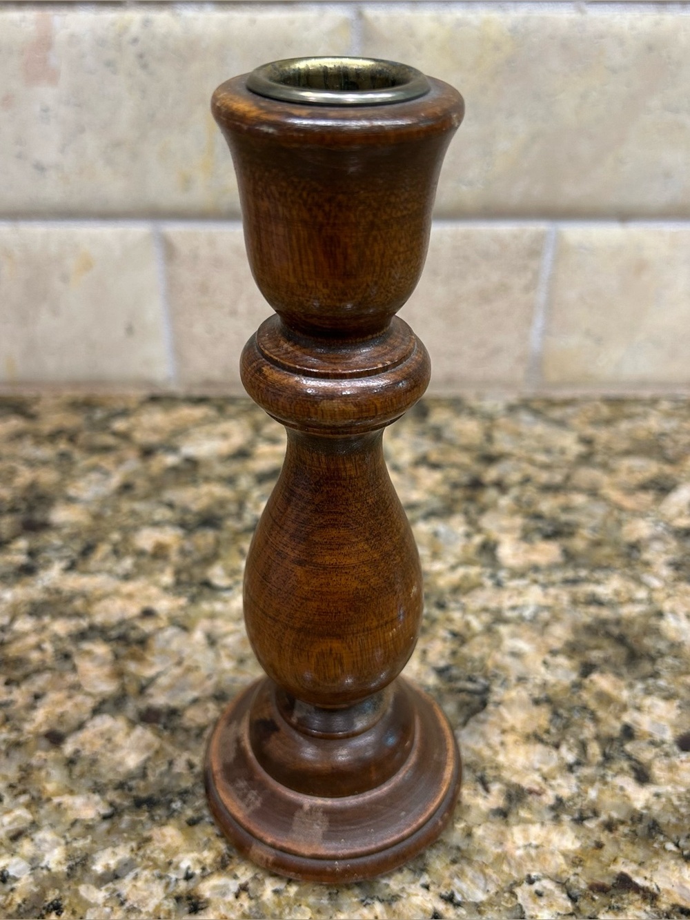 Vintage turned wood candlestick holder featuring a metal brass insert